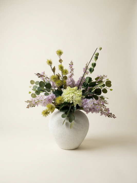 Floral arrangement in a white vase on a light background