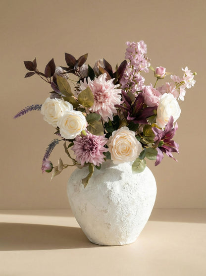 White textured vase with a bouquet of flowers on a beige background