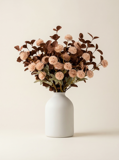 White vase with brown dried flowers on a beige background