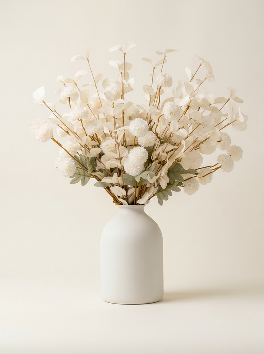 White vase with dried flowers on a beige background