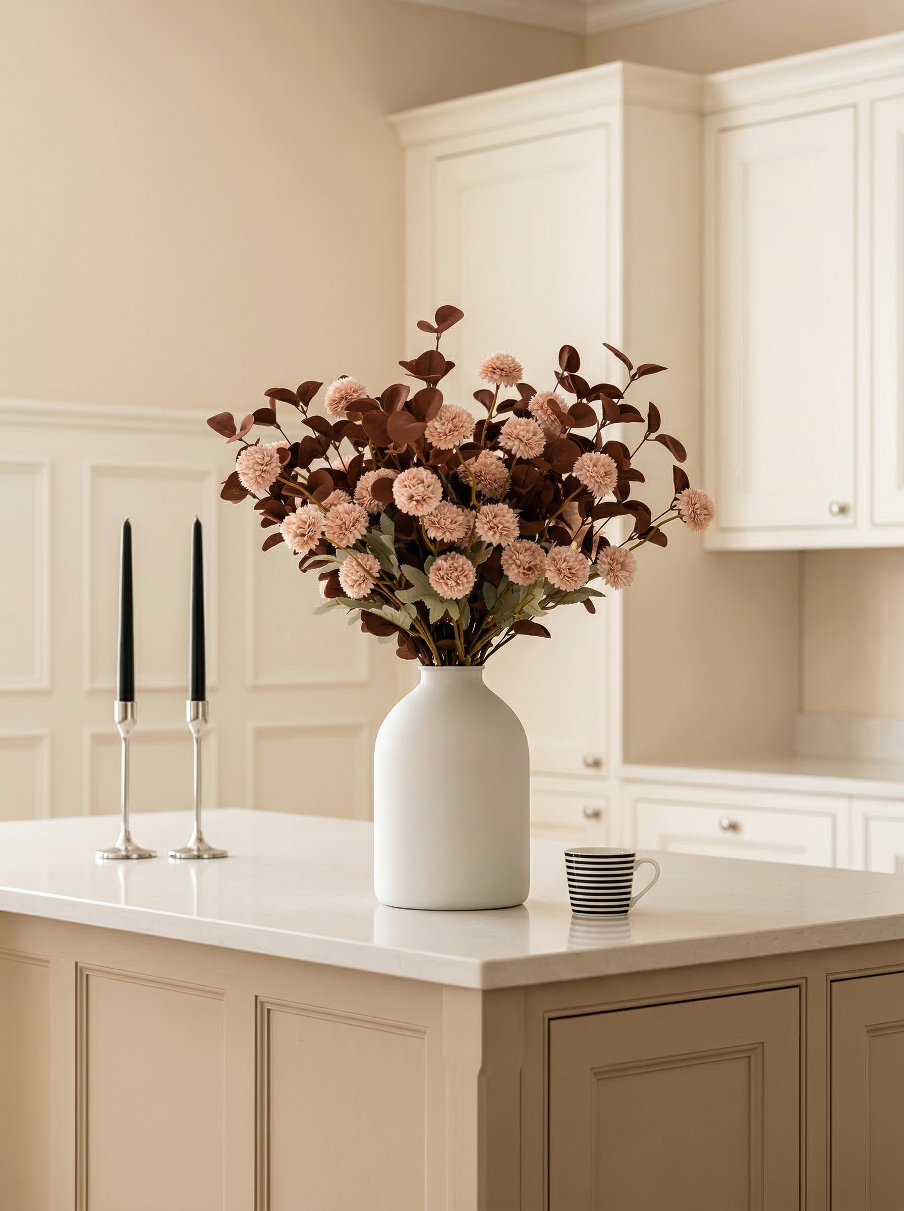 White vase with pink flowers on a kitchen counter